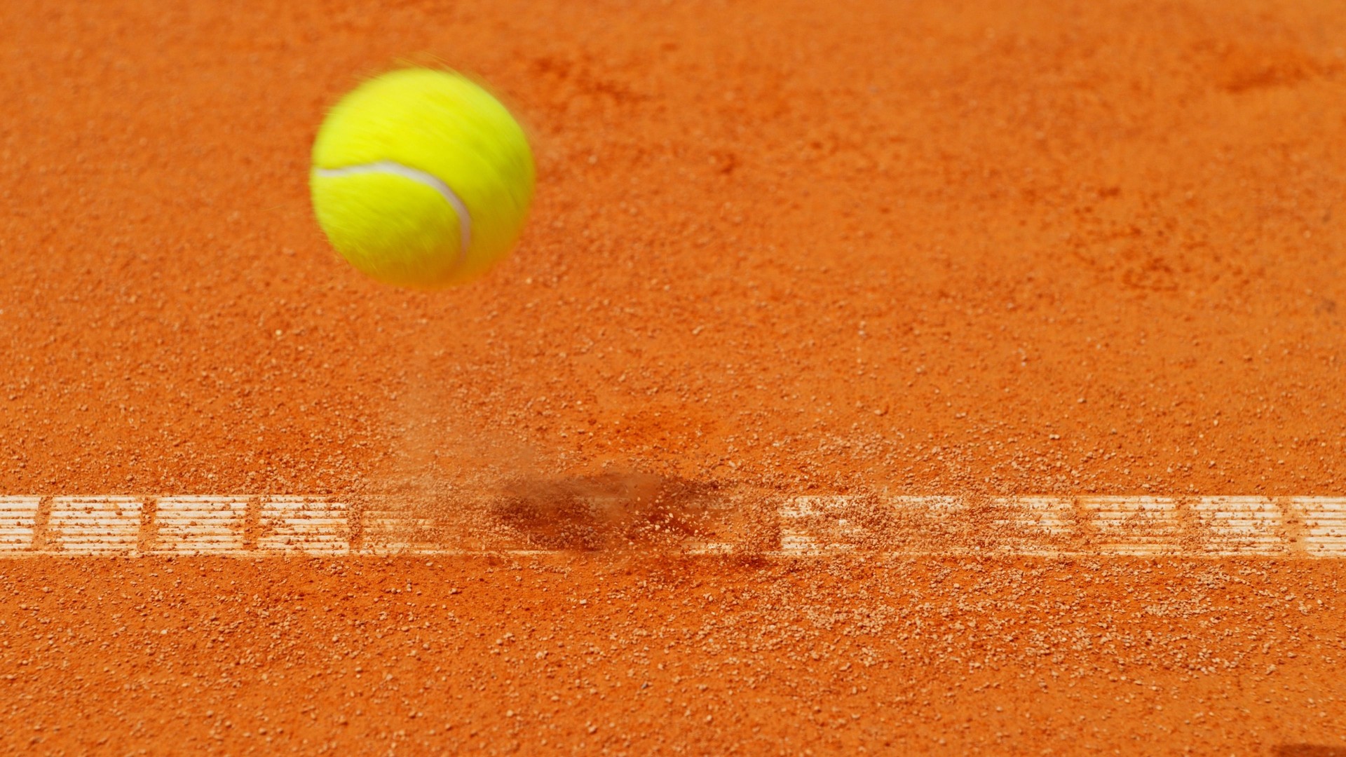 Freeze motion of flying tennis ball in court.