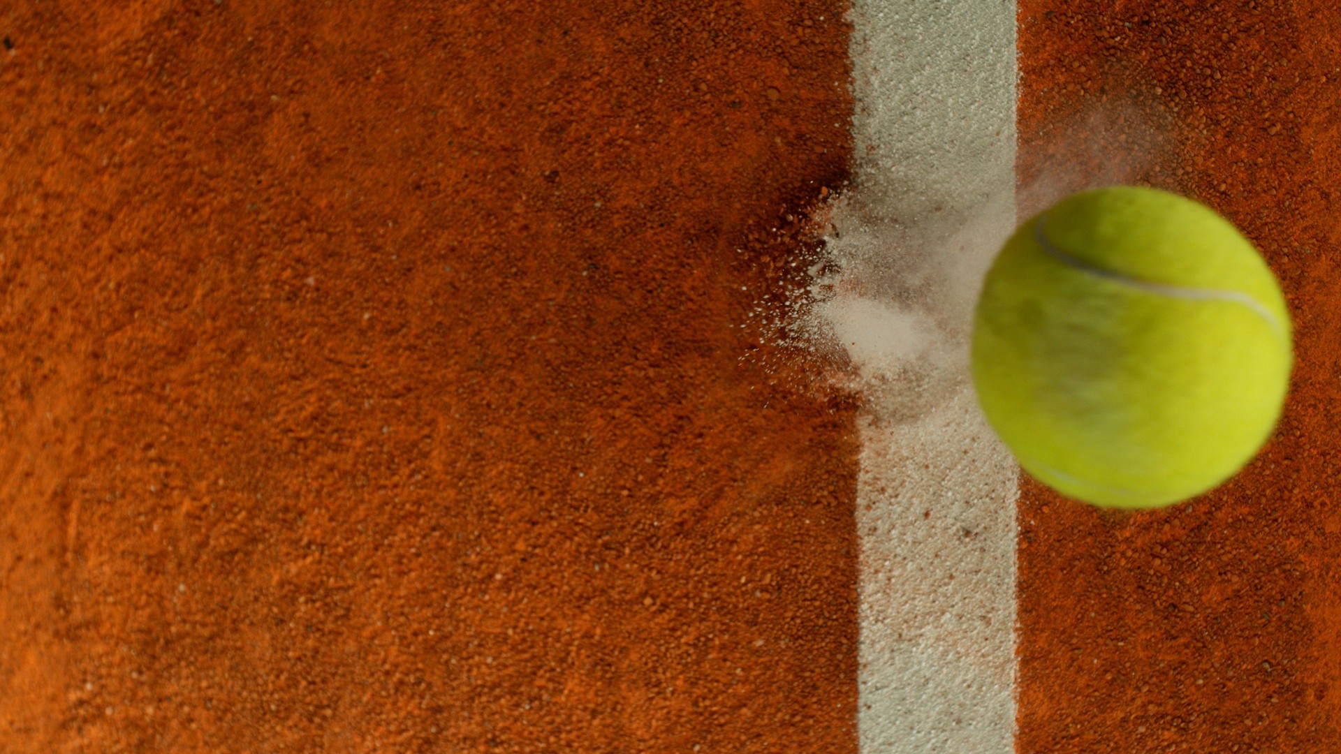 Tennis Ball Hitting a Clay Court